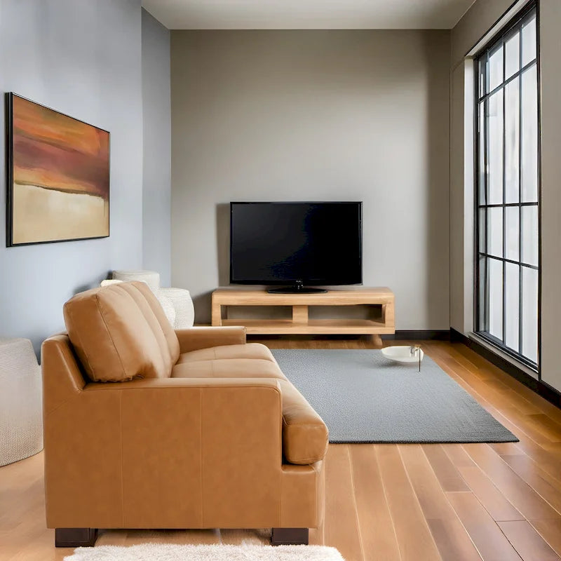 Canapé 3 places haut de gamme en cuir véritable, avec assise profonde et moelleuse et coussins en plumes d'oie pour un confort optimal.