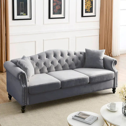 Canapé Chesterfield 3 places capitonné avec accoudoirs arrondis et clous décoratifs
