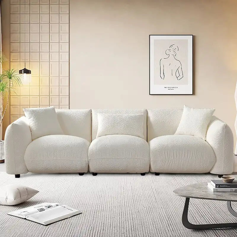 Canapé d'angle blanc confortable et moelleux, garni de duvet d'agneau, avec pouf