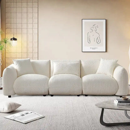 Canapé d'angle blanc confortable et moelleux, garni de duvet d'agneau, avec pouf